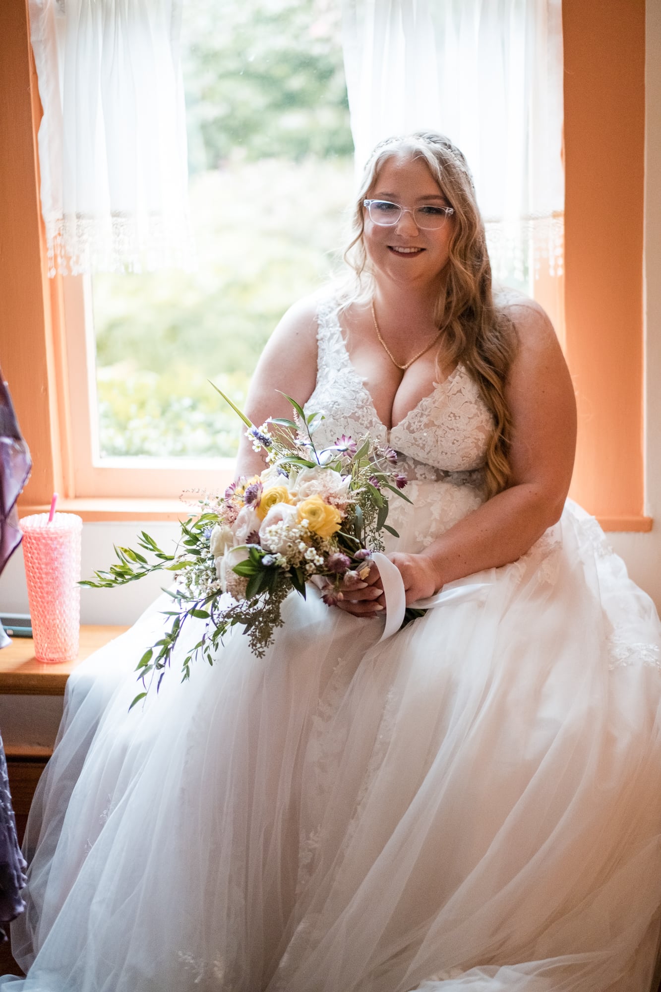 bride sitting with flowers